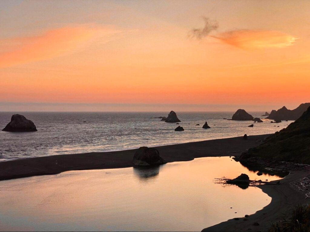 View of the calm eater and rock formations in Goat Rock at sunset