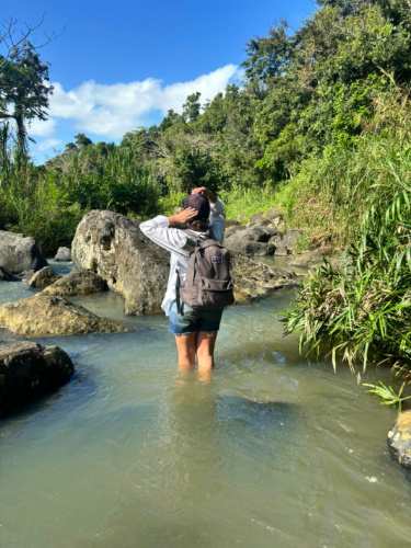 The author Vanessa Ramos passing a river going to Los Pilones Waterfall