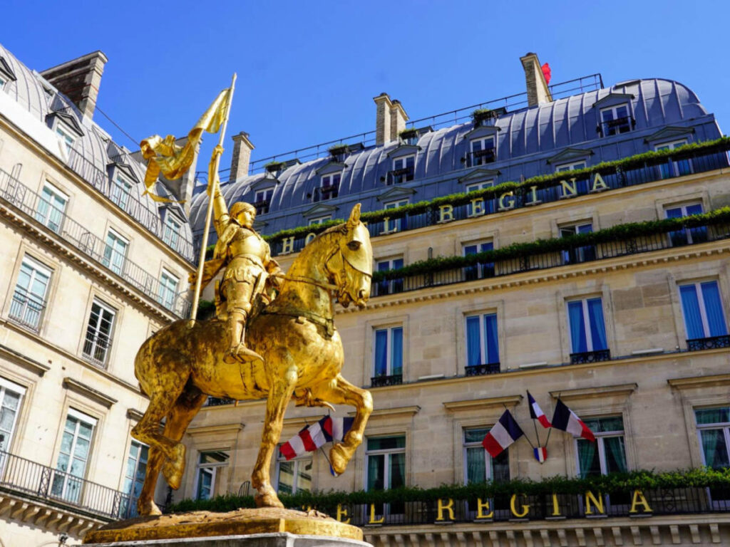 View of the Golden Joan of Arc statue in front of Hotel Regina Louvre