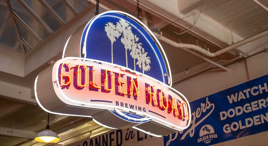 The Golden Road Brewery neon sign hanging on the ceiling