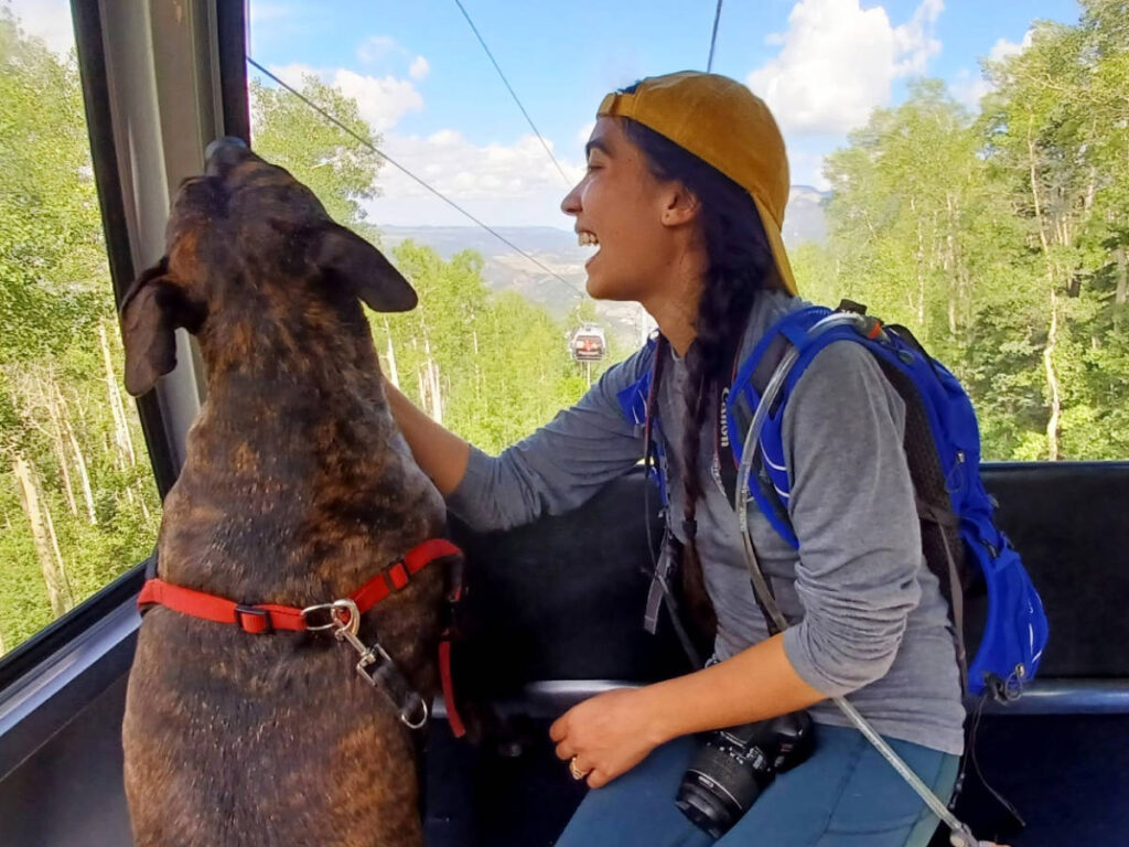 The author, Abigail Bliss with her dog riding the gondola to Mountain Village