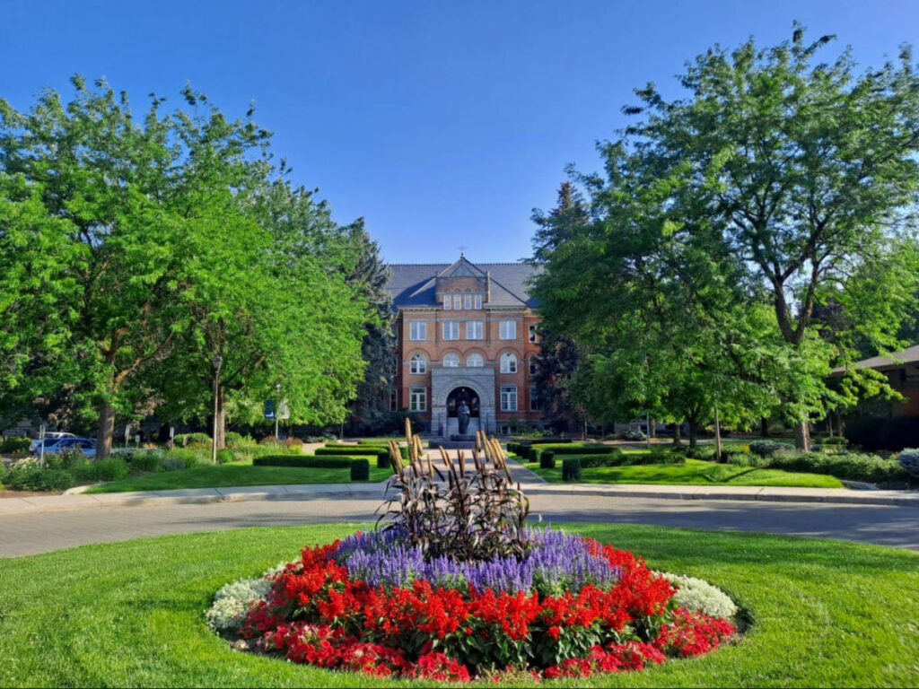 A large building at Gonzaga University, featuring a flower bed in front