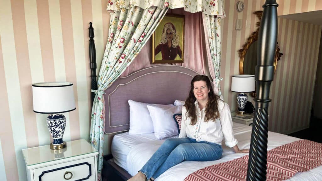 The author Elizabeth Demolat sitting on the bed of Graduate Hotel room, Graduate Nashville Review