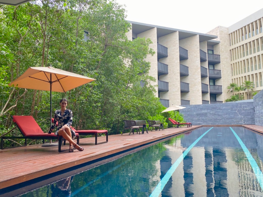 Clara posing for a picture near the interior pool in Grand Hyatt