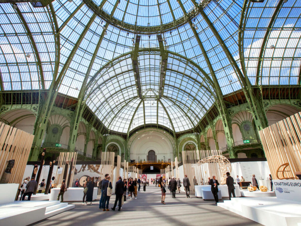 People looking at exhibitions inside the Grand Palais
