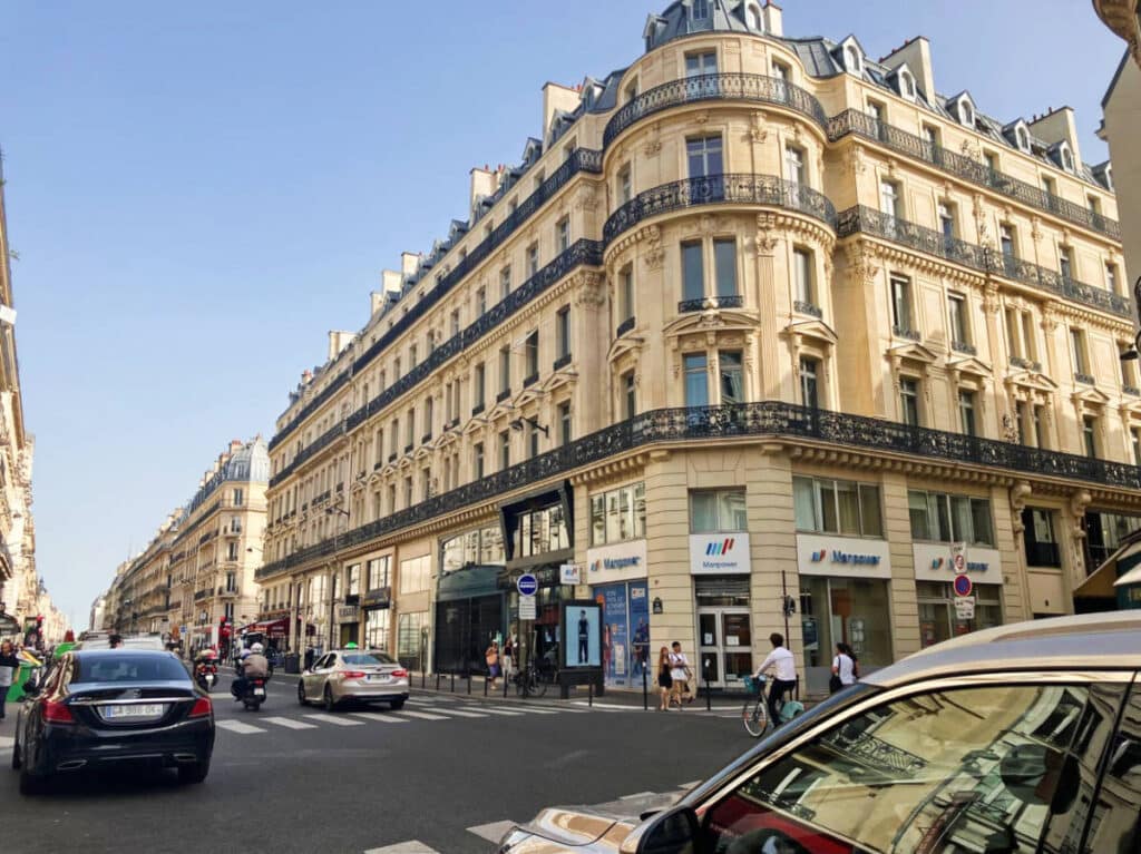 View of buildings, cars, and people at the Grands Boulevards neighborhood
