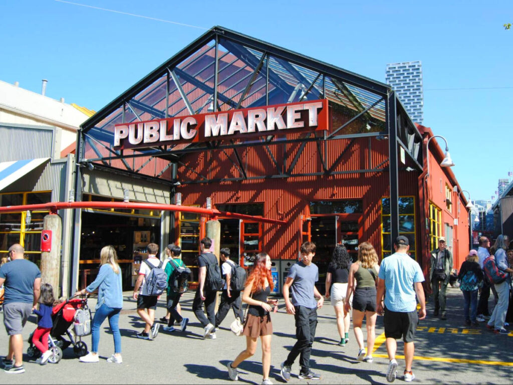 People strolling in front of Granville Island's bustling public market