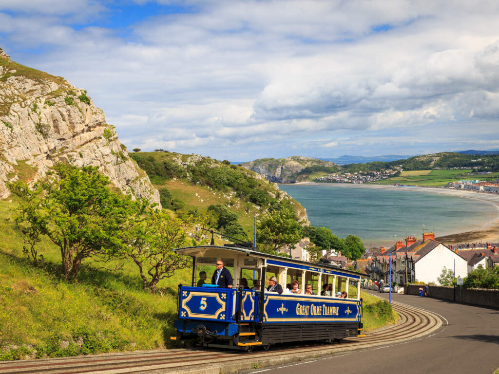 The Great Orme Tramway passing by a town in Wales
