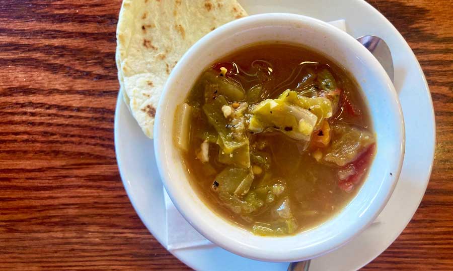 A green chile on a bowl and a wrap on a plate at Cherry Cricket