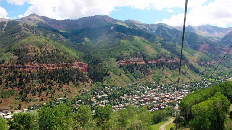 View of Telluride surrounded by a lush green mountain valley
