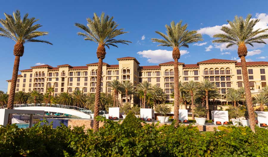 The Green Valley Ranch Resort and palm trees in front of it