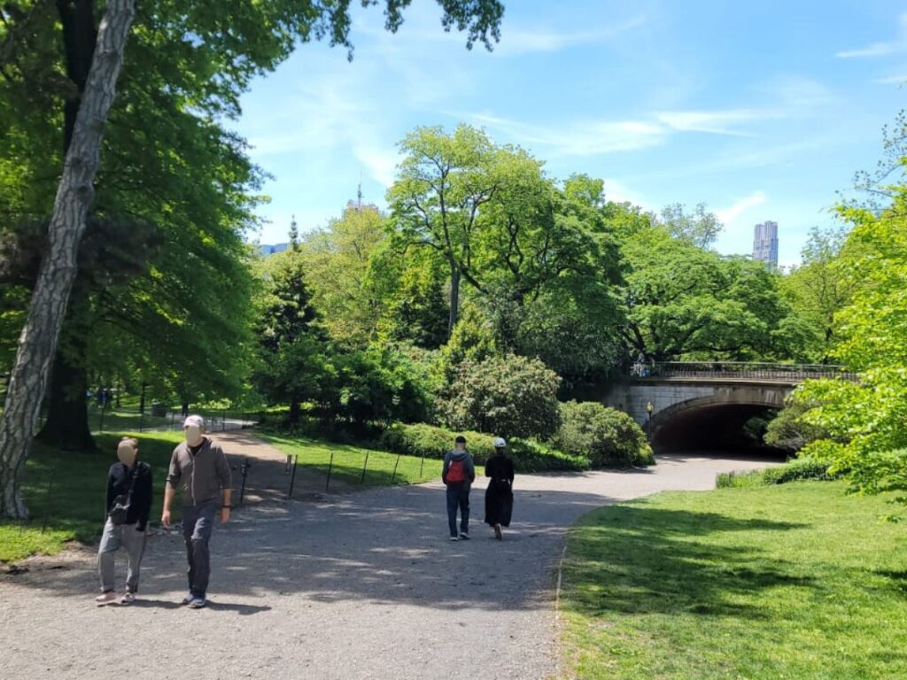 People strolling near the Greyshot Arch at Central Park