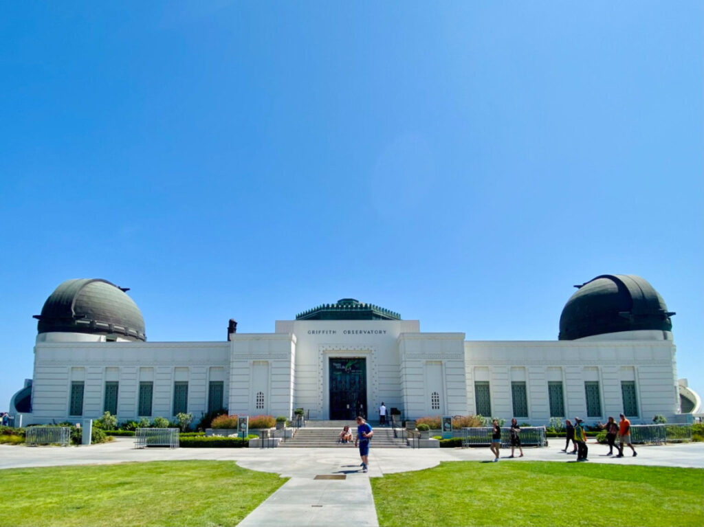 Front view of the Griffith Observatory against a blue sky backdrop
