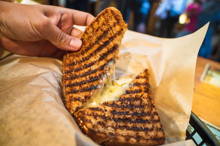 View of a hand holding grilled cheese