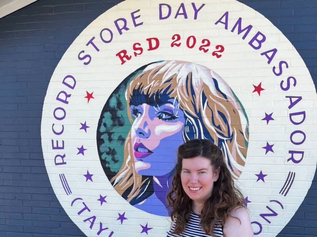 The author, Elizabeth Demolat smiling for a photo outside the Grimey’s Record Store