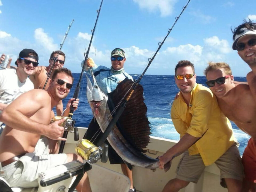 A group of men fishing with a huge catch of fish on the boat