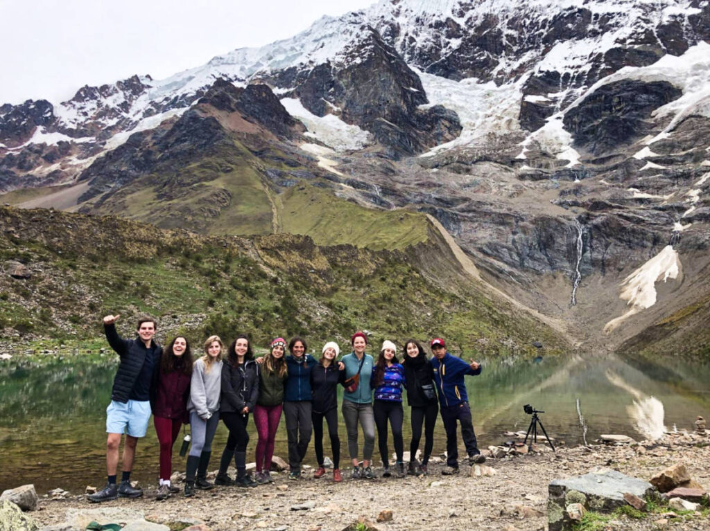 A group of hikers with the snow capped mountain at Salkantay Trail