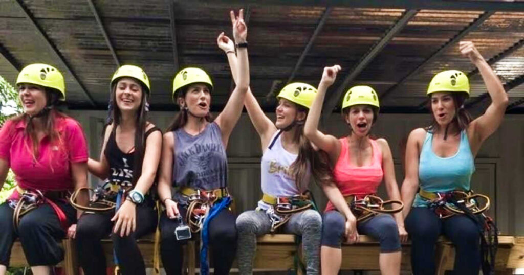 A group of women with their helmets on for the zipline ride