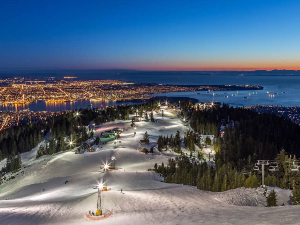 Overlooking view of city lights at night in Vancouver from Grouse Mountain