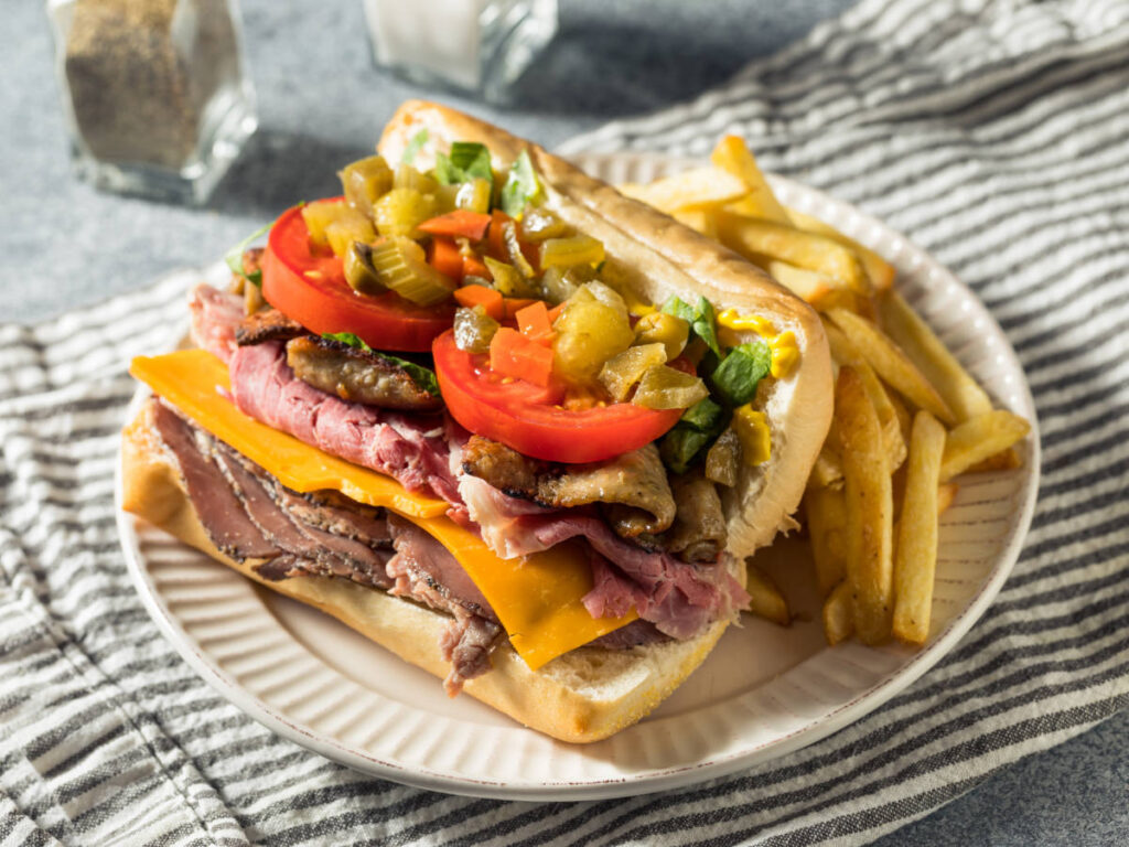 A “gym shoe” sandwich with fries on a plate