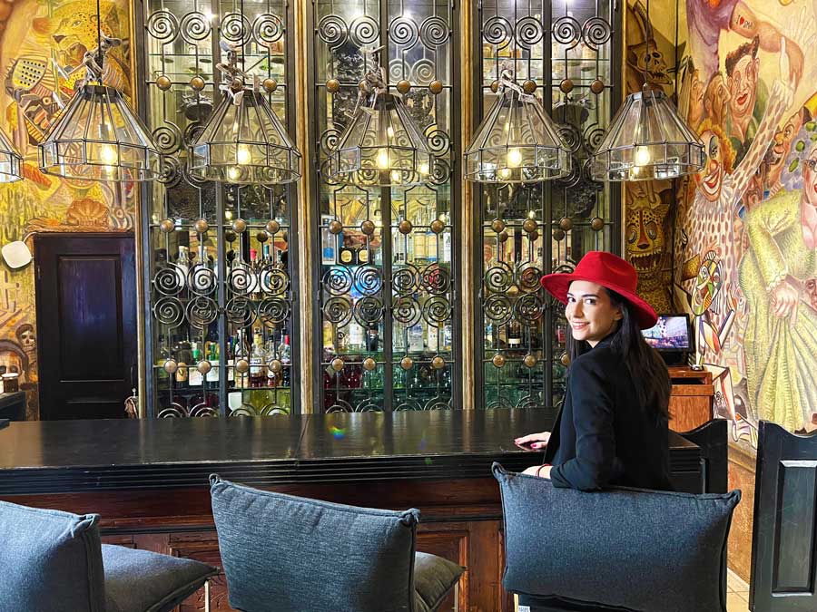 Clara sitting on a bar stool in Hacienda El Santuario