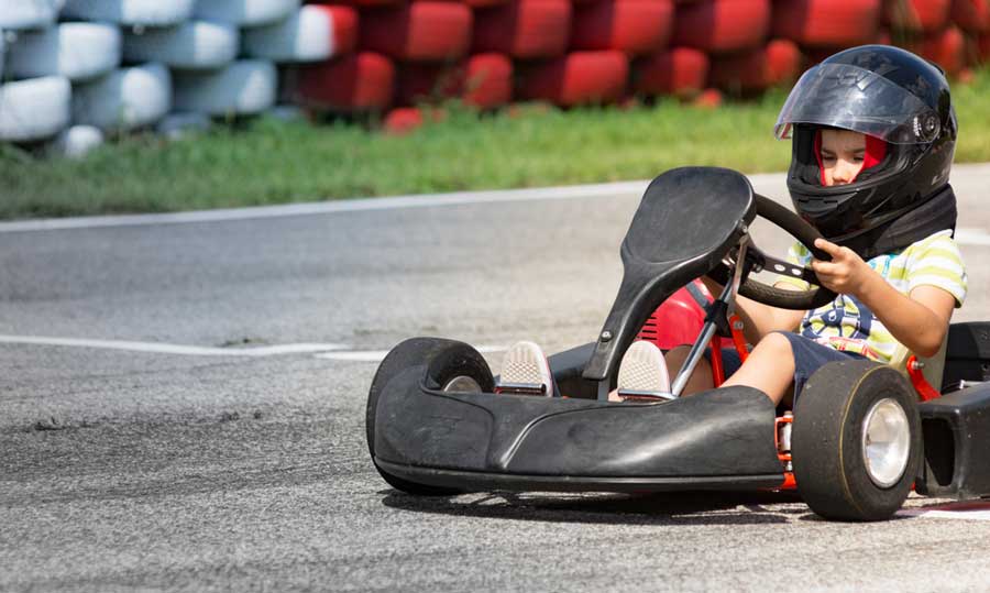 A boy riding a go-kart in Hacienda Recreativa Mar Chiquita