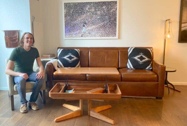 The author sitting in a living room of a suite at the Halcyon Hotel in Cherry Creek, Denver