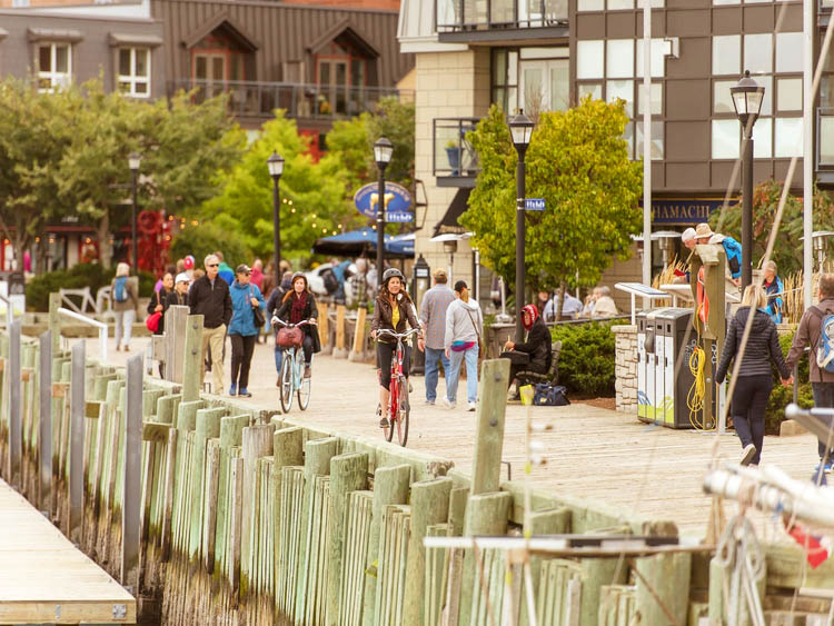 People riding on bike at boardwalk