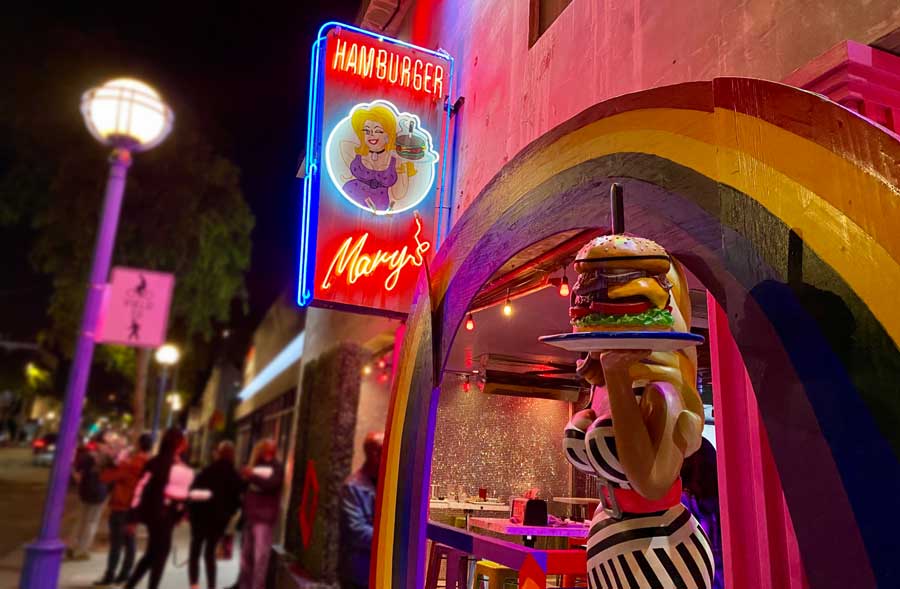 The illuminated sign of Hamburger Mary’s from the entrance