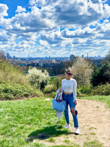 The author, Brooke, posing at the to of the hill with the Hampstead Heath neighborhood in the background