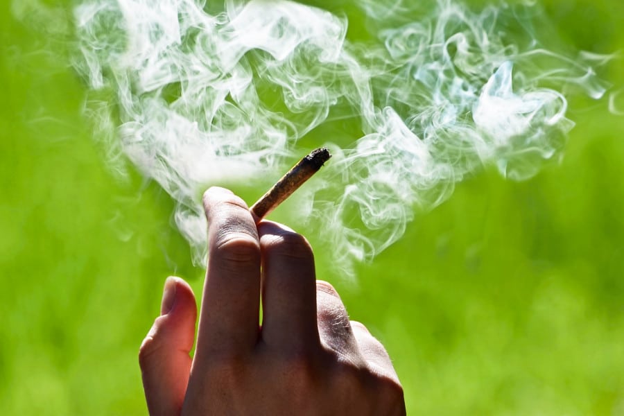 Marijuana in hand with lots of smoke