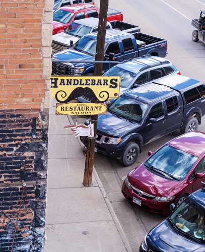 The Handlebars Food & Saloon sign in front of it