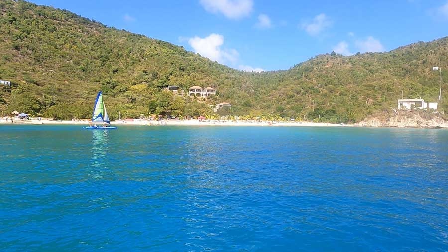 The blue water from Hansen Bay Beach and the clear blue sky over it