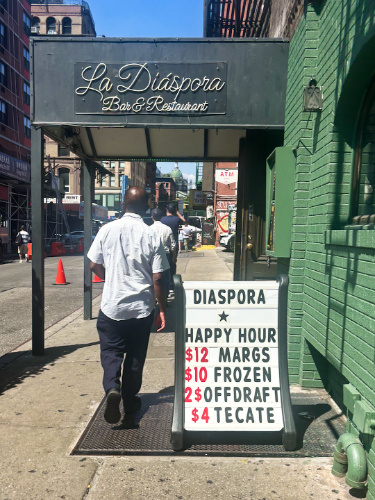 A signage of the happy hour sign in NYC