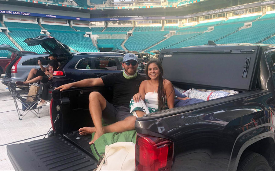 The author and his wife on the trunk of their car in Hard Rock Stadium