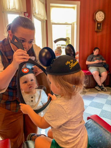 A child looking at a mirror after his hair cut at Harmony Barber Shop