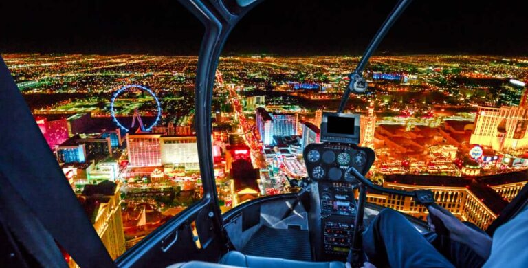 View of the scenic illuminated skyscrapers of downtown Las Vegas from the inside of a helicopter ride at night