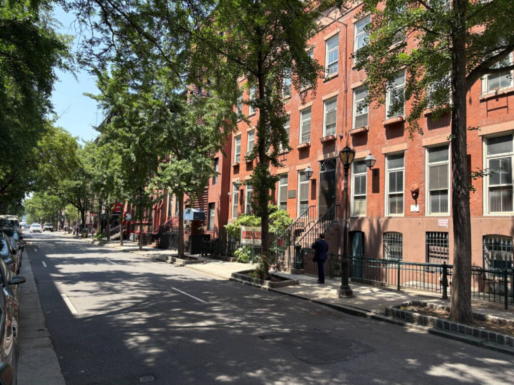 View of houses and trees lined on a street in Hell's Kitchen