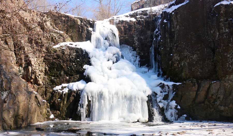 View of the frozen Hemlock Falls during wintertime