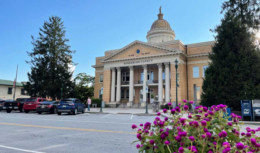The Henderson County Courthouse from the outside under the clear blue sky