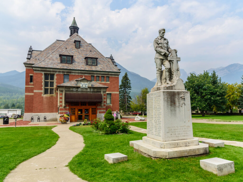 The Fernie Courthouse on the Heritage Walking Tour, where a statue of a man graces the building's entrance