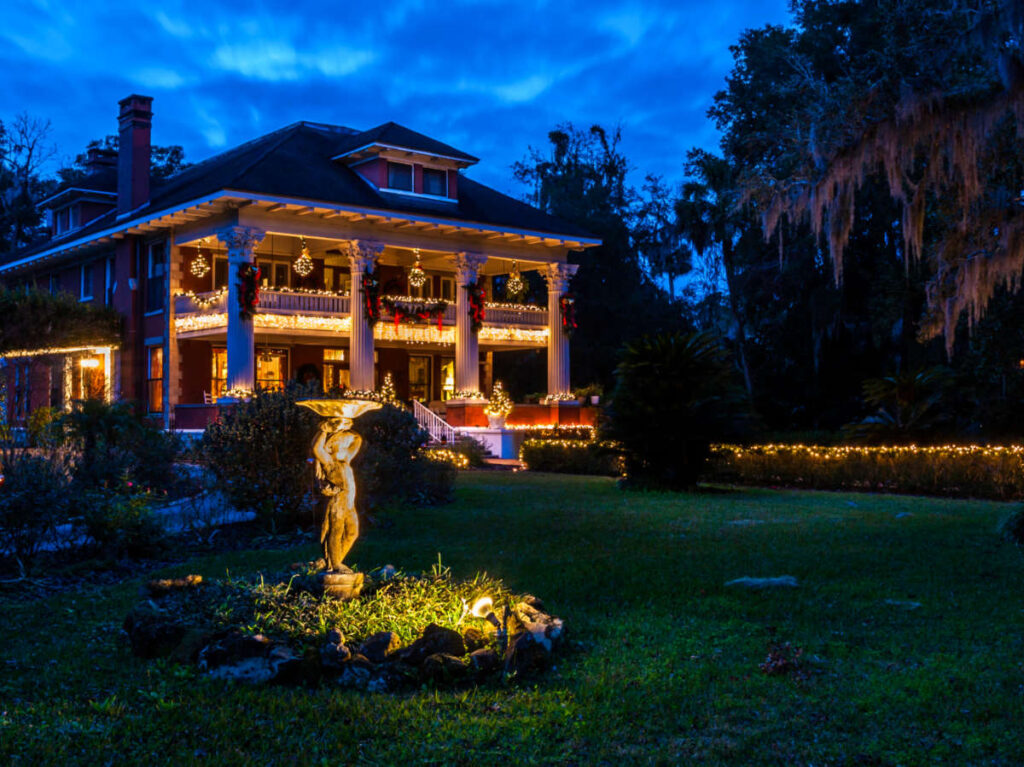 View of the exterior of Herlong Mansion with Christmas decorations at night