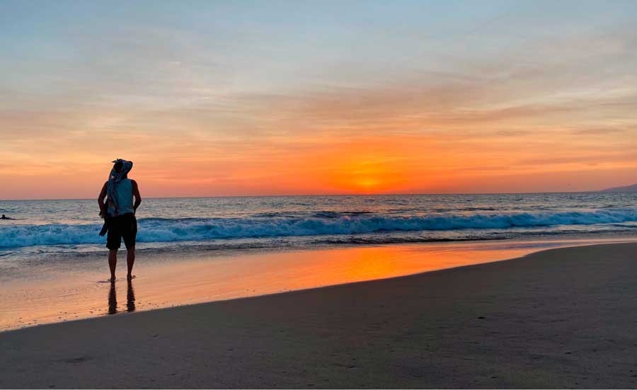 View of a person admiring the sunset in Hermosa Beach