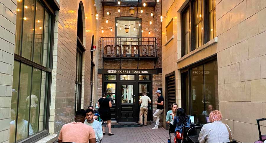 People enjoying their drinks on the alley patio area of Hero Coffee Bar