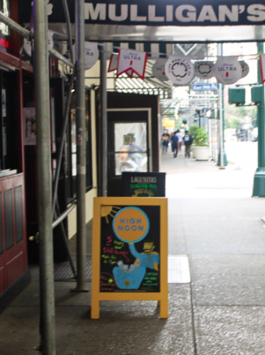 A signage of the happy hour sign in High Noon
