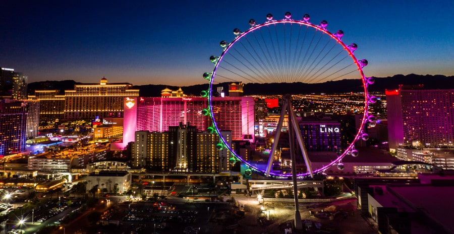 Aerial view of the massive Ferris wheel, Las Vegas strip and valley beyond during the dusk