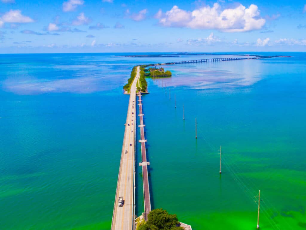 Aerial view of a highway surrounded by blue water in Key West