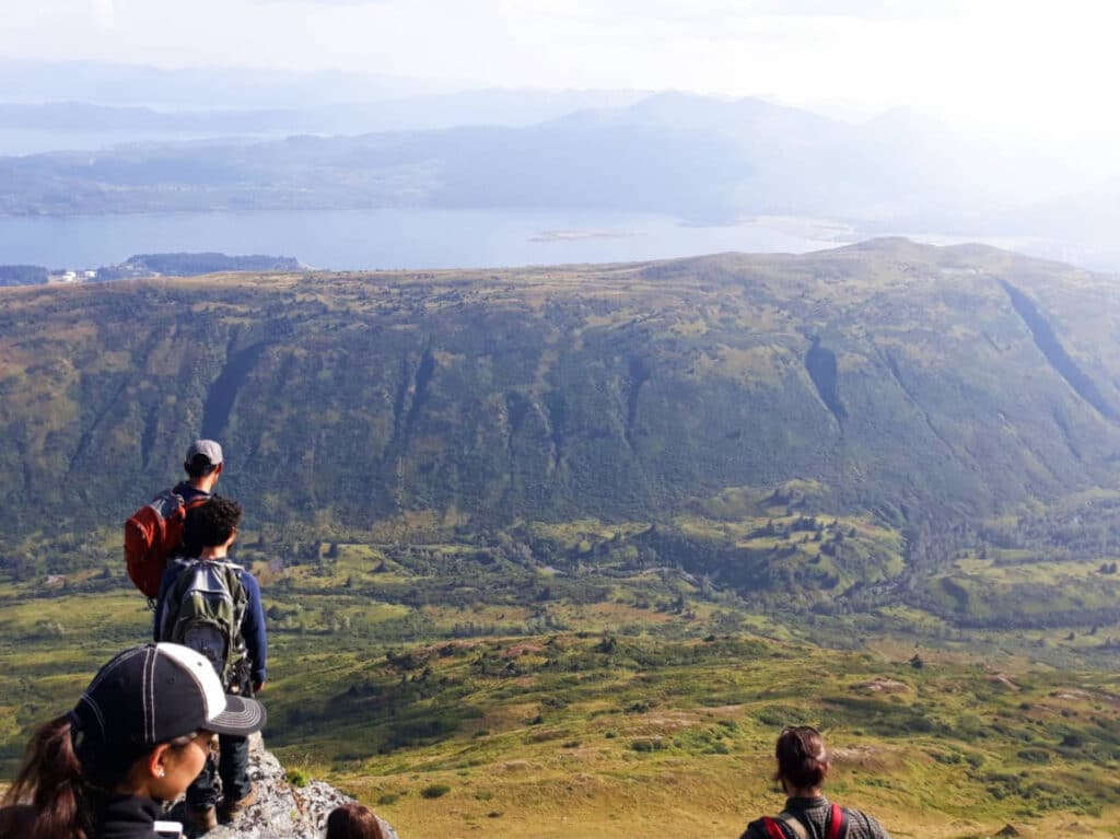 Overlooking view of hikers during their hike in Kodiak Island