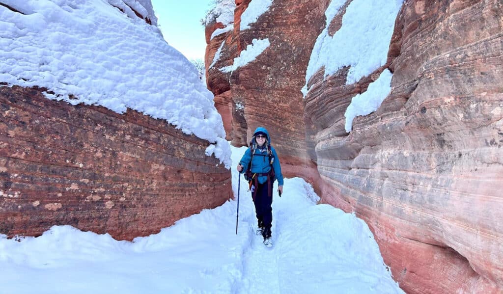 The author's friend on a snowy slot canyon in Utah