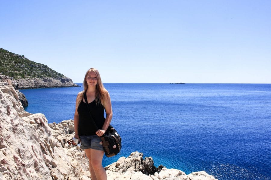 Taylor stands on a cliff while on the hike to Odysseus Cave